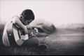 boy is playing on the guitat